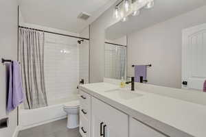 Full bathroom with vanity, toilet, and shower / tub combo