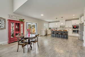 Dining room with light hardwood / wood-style flooring