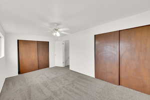 Unfurnished bedroom with carpet and ceiling fan