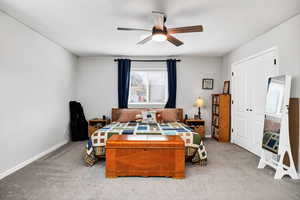 Bedroom with ceiling fan and carpet