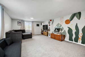 Living room with carpet floors and a textured ceiling