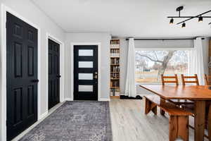 Foyer featuring wood-type flooring and track lighting