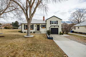 Tri-level home with a garage, a mountain view, and a front yard