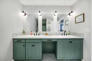 Bathroom with vanity and decorative backsplash