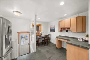 Kitchen featuring stainless steel fridge with ice dispenser