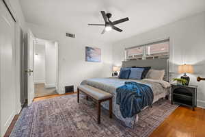 Bedroom featuring wood-type flooring, ceiling fan, and a closet