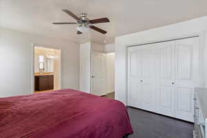 Bedroom with ceiling fan, dark hardwood / wood-style floors, vaulted ceiling, and a textured ceiling