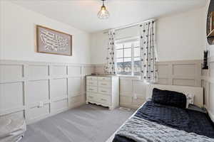 Bedroom featuring light colored carpet and a textured ceiling