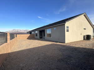 Rear view of house featuring a mountain view and central air condition unit