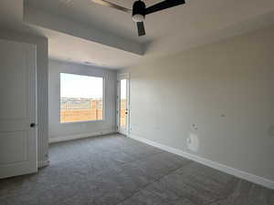 Spare room with ceiling fan and carpet flooring