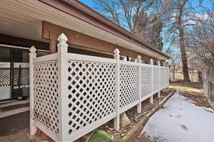 View of snow covered exterior featuring fence