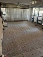 Unfurnished room featuring ceiling fan and carpet flooring