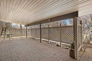 View of patio featuring fence