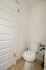 Bathroom with tile patterned floors and toilet