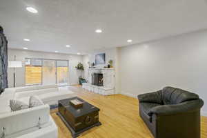 Living room with hardwood / wood-style flooring and a textured ceiling