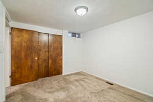 Unfurnished bedroom with a closet and carpet