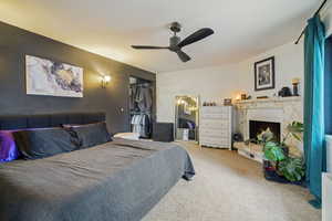 Carpeted bedroom with ceiling fan