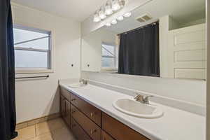 Bathroom featuring tile patterned flooring and vanity