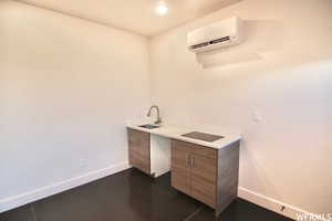 Bathroom featuring a wall unit AC and sink