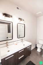 Bathroom featuring vanity and toilet