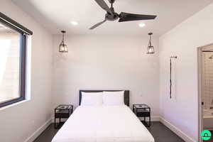 Bedroom with multiple windows and ceiling fan