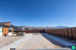 View of yard featuring a mountain view, a patio area, and a jacuzzi