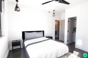 Bedroom featuring ceiling fan and a walk in closet