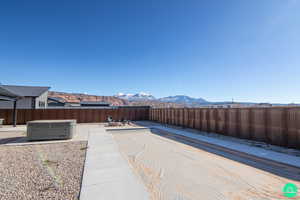 View of patio with a hot tub and a mountain view