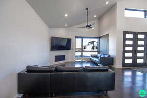 Living room featuring high vaulted ceiling, french doors, and ceiling fan