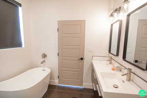 Bathroom featuring vanity and a tub