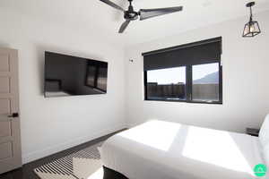 Bedroom with ceiling fan and dark hardwood / wood-style flooring