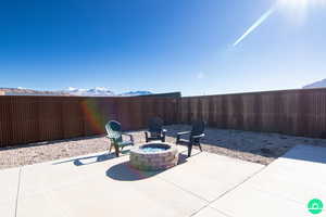 View of patio / terrace with a mountain view and a fire pit