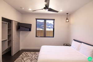 Bedroom with dark hardwood / wood-style floors and ceiling fan