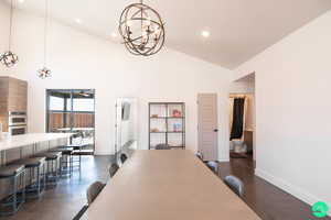 Dining area featuring an inviting chandelier and high vaulted ceiling