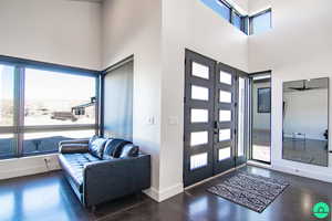 Foyer entrance featuring french doors, a towering ceiling, and plenty of natural light