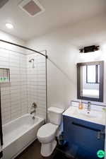 Full bathroom with vanity, toilet, and tiled shower / bath combo