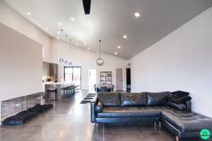 Living room featuring an inviting chandelier and high vaulted ceiling