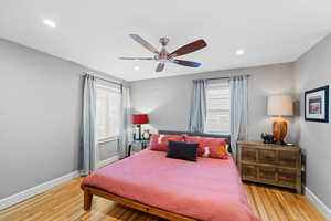 Bedroom with light hardwood / wood-style flooring and ceiling fan