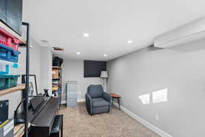 Sitting room featuring light colored carpet