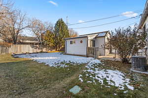 Snowy yard featuring central AC