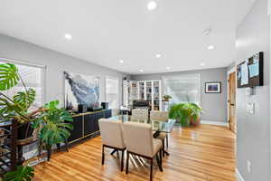 Dining space with light hardwood / wood-style flooring