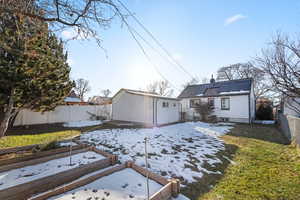 Snow covered house featuring a yard