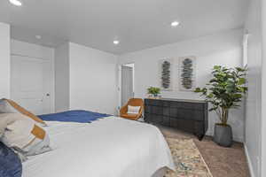 Carpeted bedroom with a textured ceiling