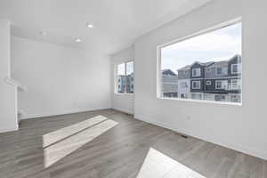 Unfurnished living room featuring wood-type flooring