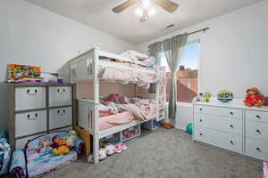 Bedroom with light colored carpet and ceiling fan