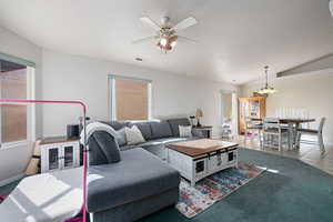 Tiled living room featuring ceiling fan