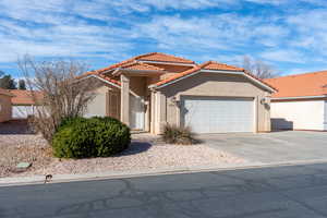 Mediterranean / spanish home featuring a garage