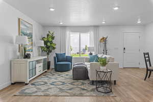 Living room featuring a textured ceiling and light hardwood / wood-style floors