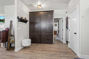 Bedroom with light hardwood / wood-style flooring