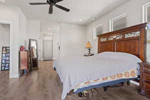 Bedroom featuring ceiling fan and wood-type flooring